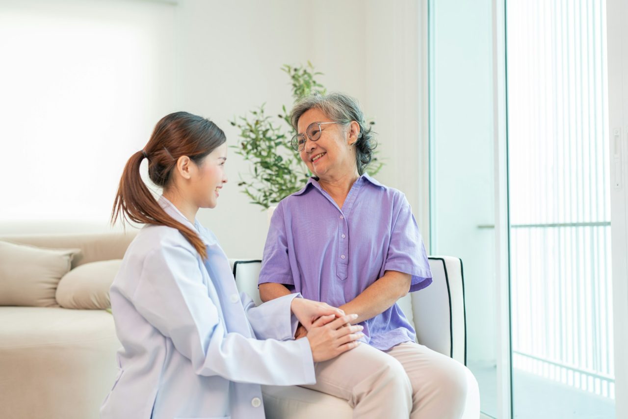 Home 2 asian female doctor taking care and talking mature female patient 1 1