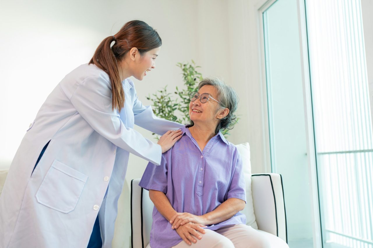 Home 9 female doctor taking care and talking mature female patient
