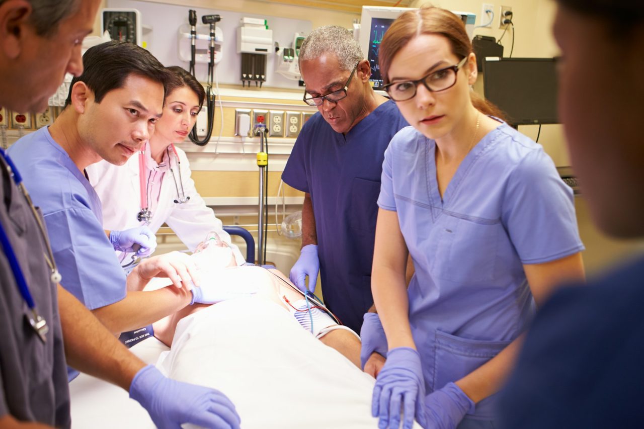 Home 7 medical team working on patient in emergency room